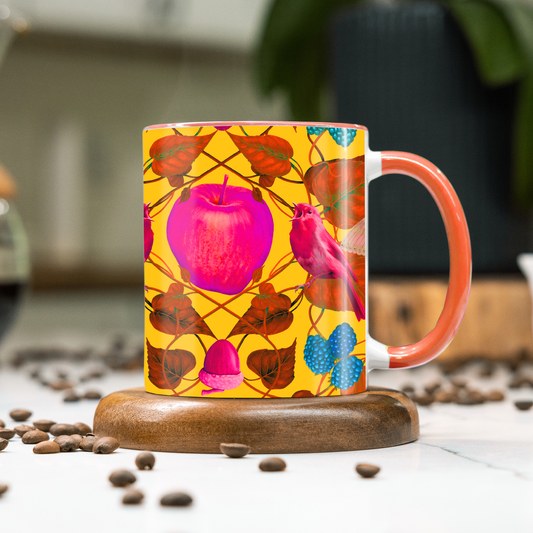 Colorful yellow mug with floral design on a wooden coaster with coffee beans around