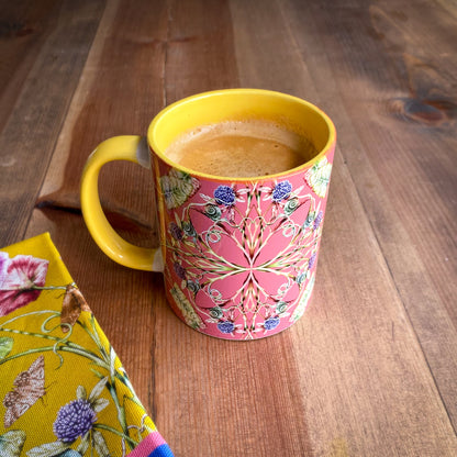 Colorful mug with floral design on a wooden surface. April Mawhinney Illustration