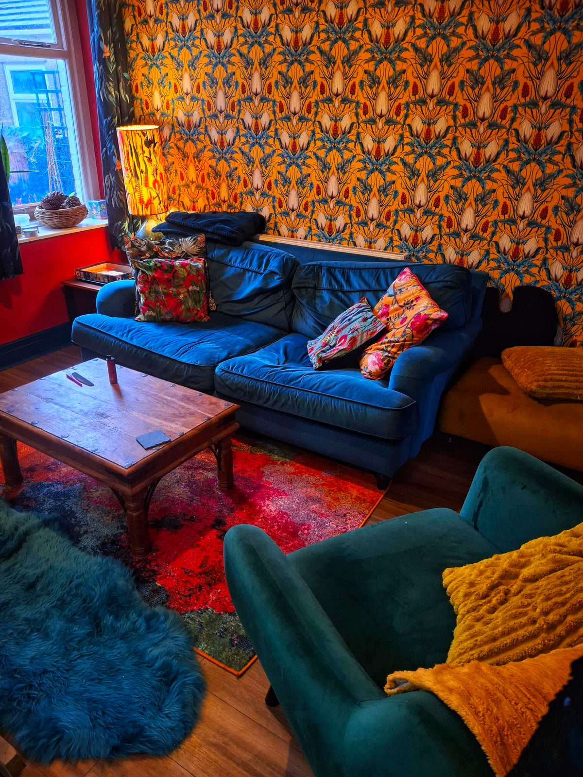 Living Room, Lords and Ladies Alchemist Yellow wallpaper, blue sofa and teal armchair with oak coffee table