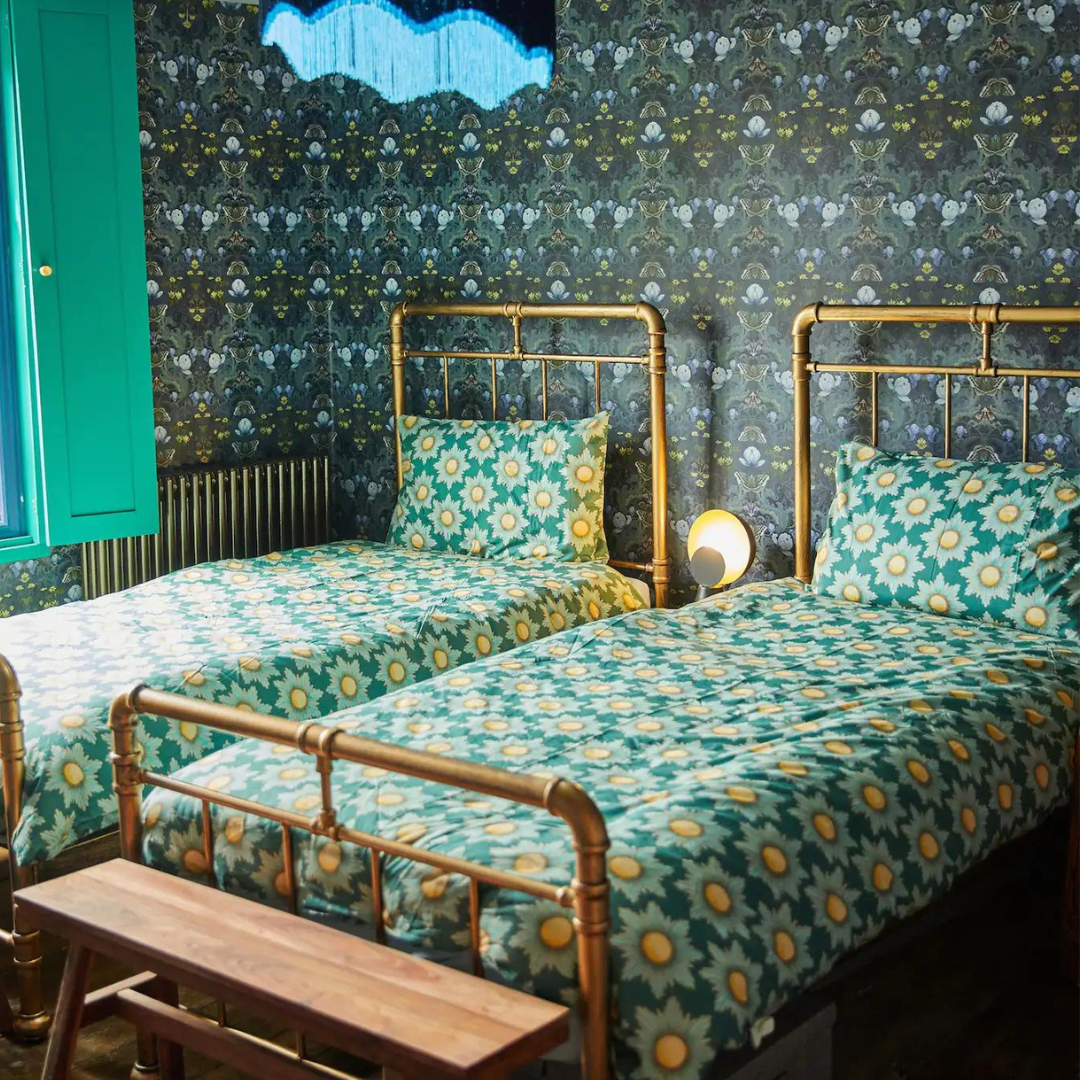 Nicola Gill, Old Stout House, Rye, Guest Bedroom, Bloomsbury Moth Wallpaper, Vintage brass bed and bold green and blue retro bed linen